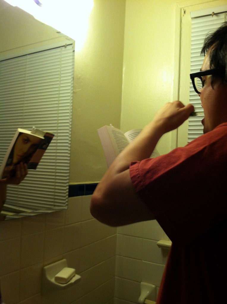 Reading while brushing my teeth.
